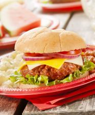 A hamburger, beans and potato salad on a plate
