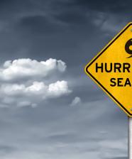 A sign displaying Hurricane Season text with a storm in the background