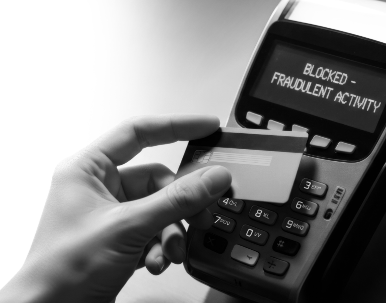 A person putting a card with a message saying blocked - fradulent activity