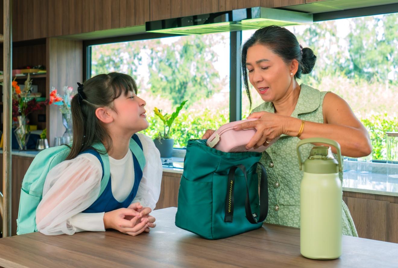 A woman with a child packing lunch