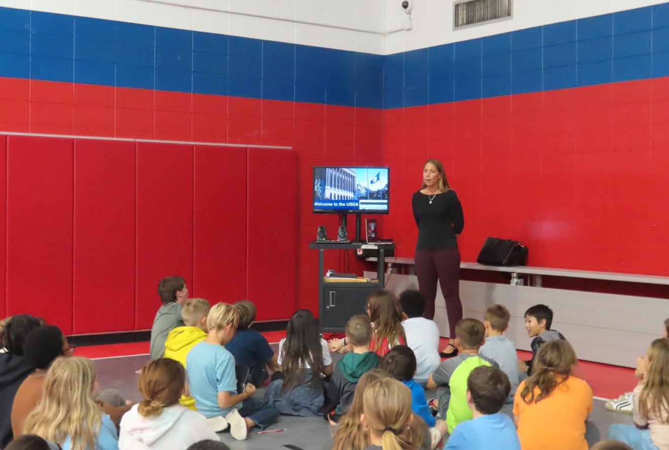 USDA Military Spouse and Veteran Employment Program Manager Christine Tomkus speaks to children about opportunities in agriculture at Whiteman AFB in Missouri