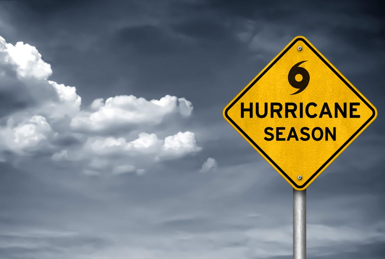 A sign displaying Hurricane Season text with a storm in the background