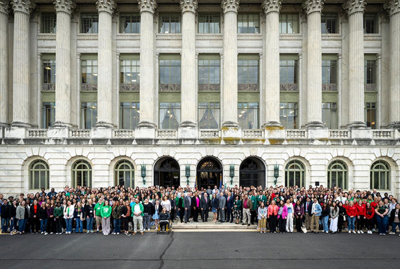 Youth delegates from the 2025 National 4-H Conference stand in front of USDA headquarters in Washington, D.C.